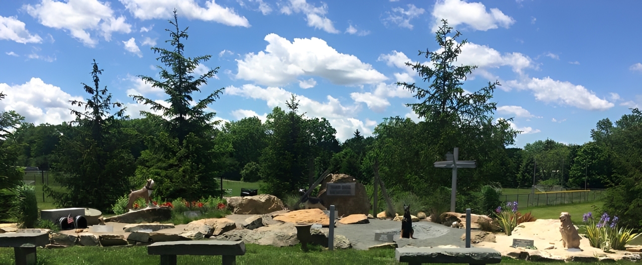 Outdoor memorial garden with trees and benches.