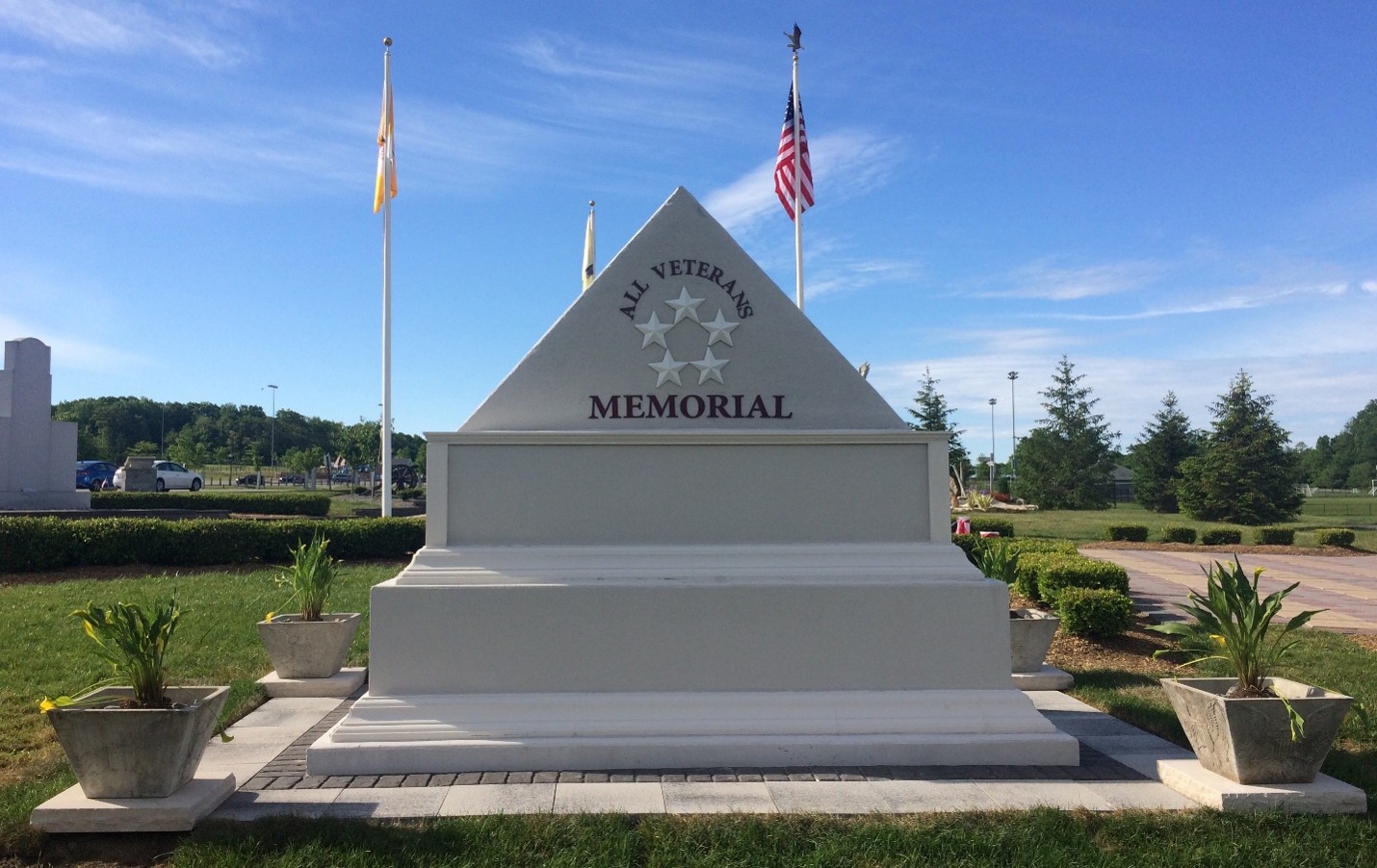 Veterans memorial with flags and plants