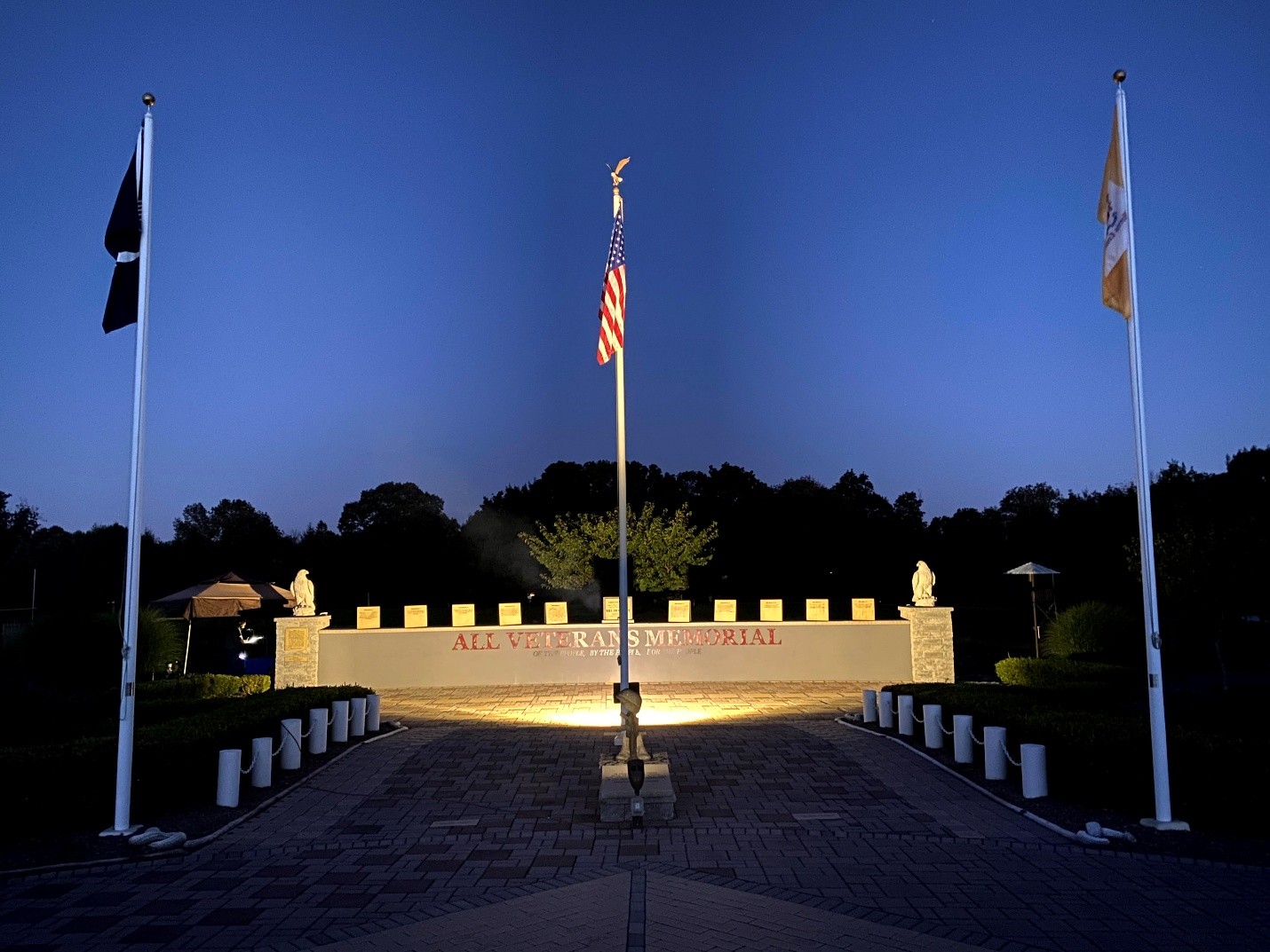Night view of memorial with flags
