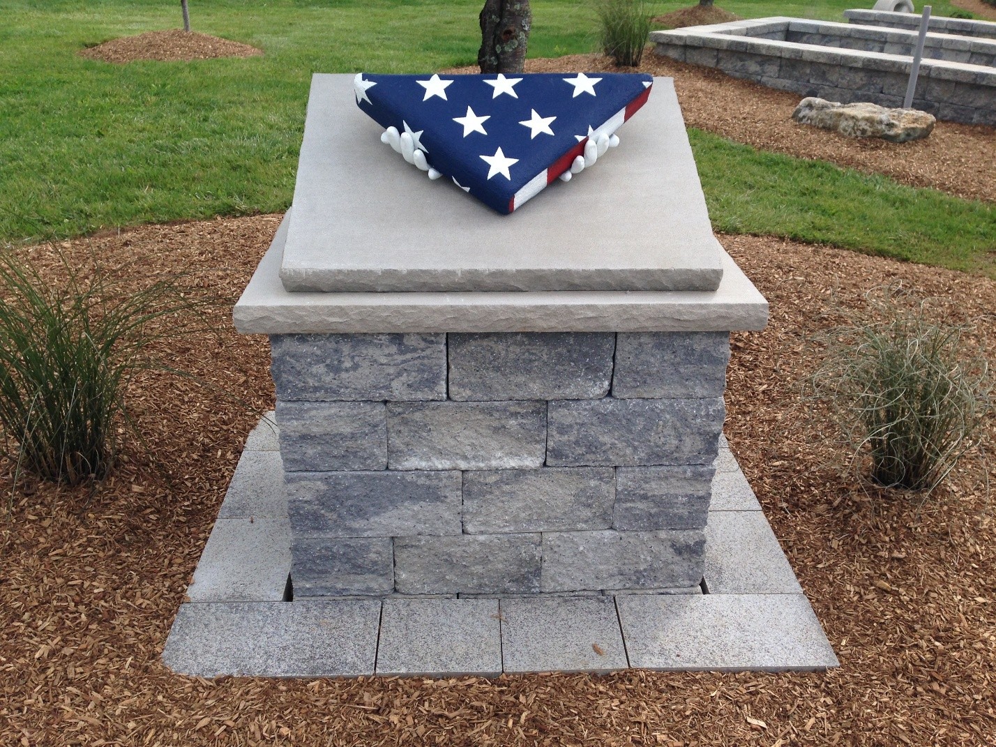 Folded American flag on stone memorial