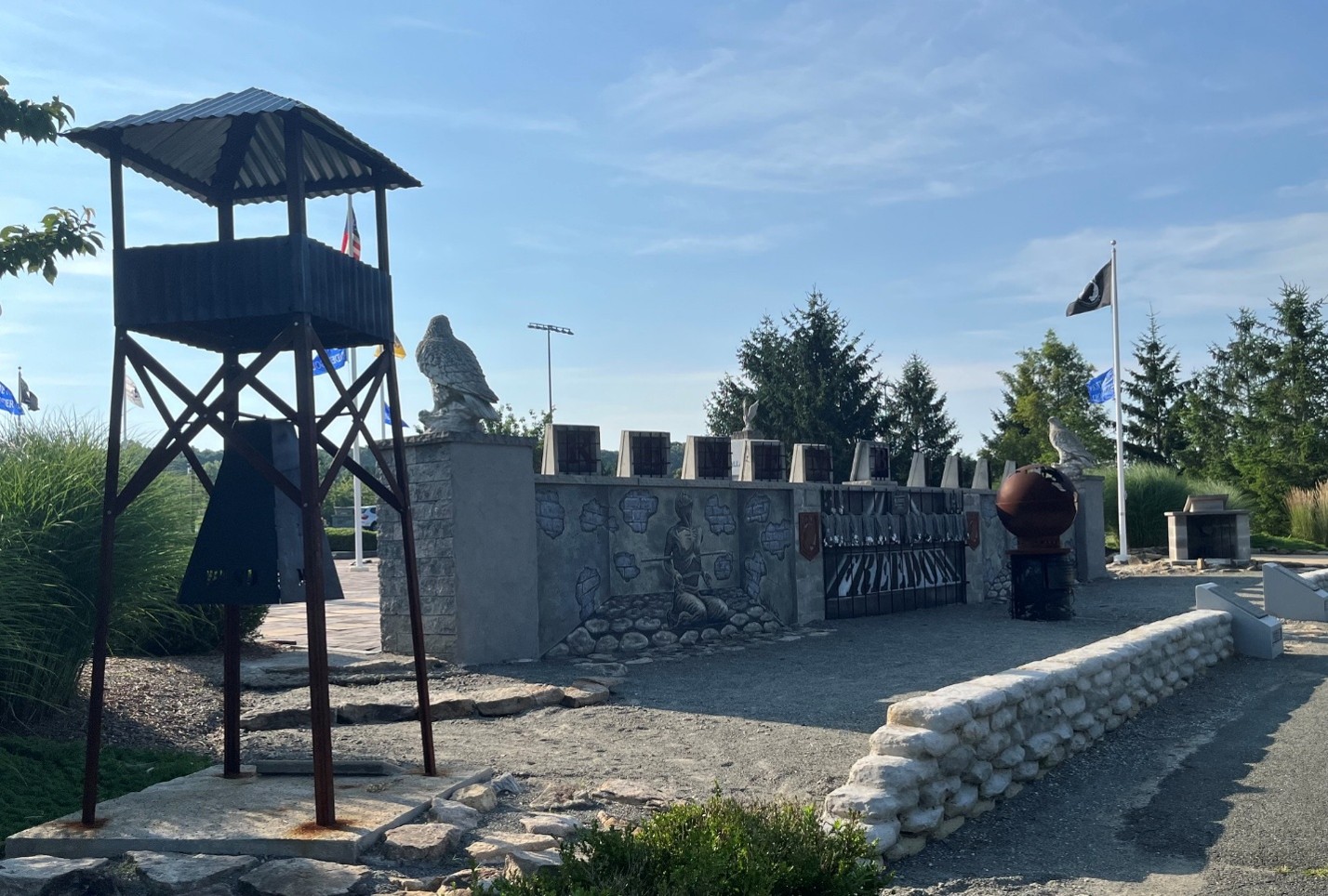 Outdoor monument with flags and sculptures