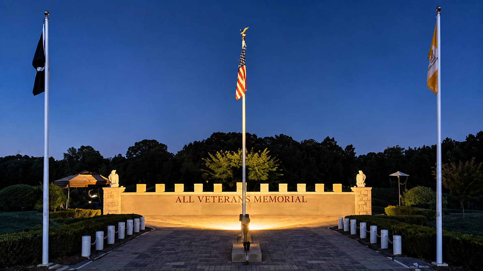 Veterans memorial with flags at twilight.