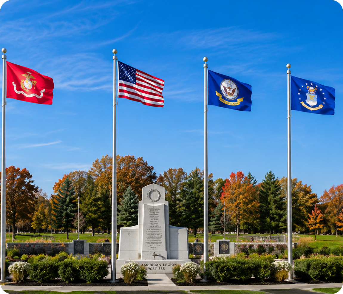 Military memorial with four flags and monument.