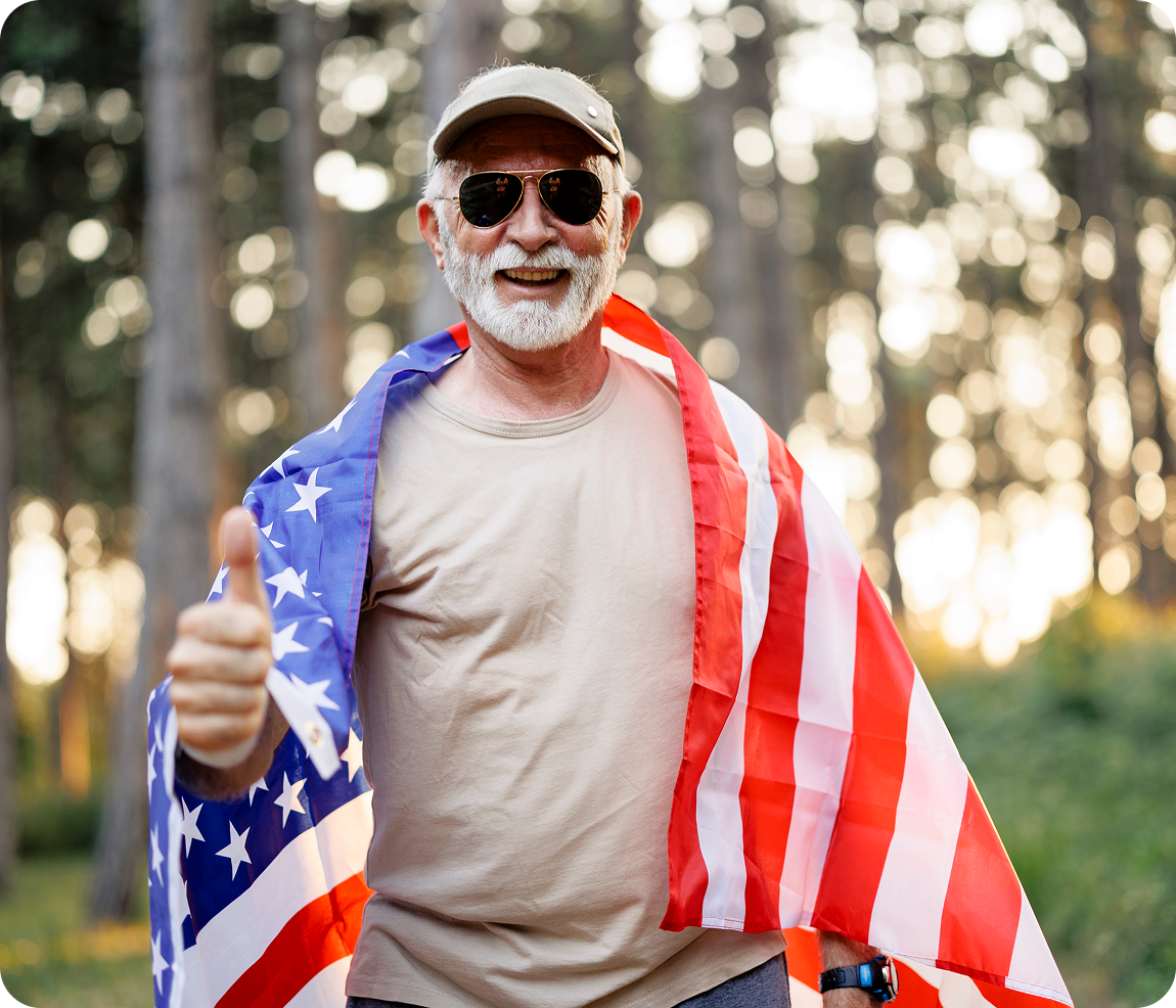 Man with American flag giving thumbs up.